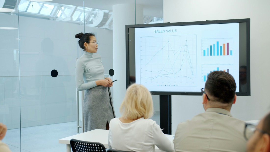 Small agency team in a meeting, reviewing work together on a shared screen